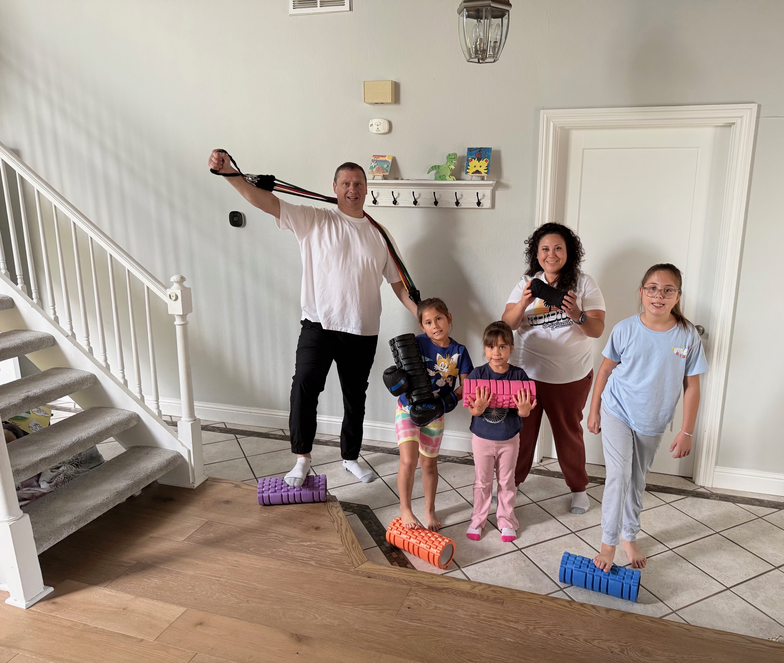 Family working out together at home with Health Hustle Academy equipment